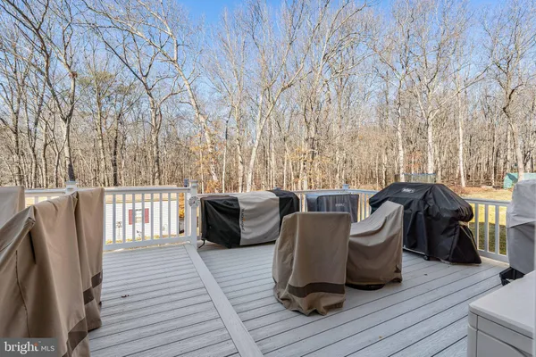 a view of a deck with table and chairs and wooden floor