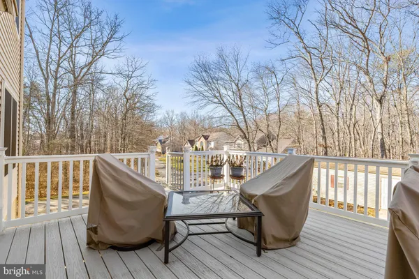 a view of balcony with wooden floor and outdoor seating