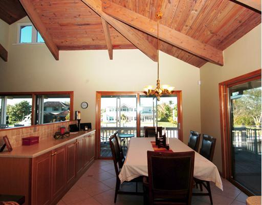 Undisclosed Address Stuart, FL 34997 - Photo 5 of 10 a dining room with furniture a chandelier and wooden floor
