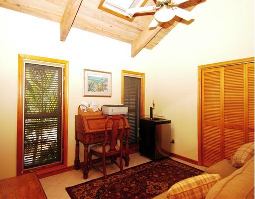 Undisclosed Address Stuart, FL 34997 - Photo 6 of 10 a bedroom with a bed and wooden floor