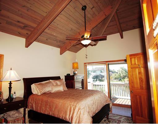 Undisclosed Address Stuart, FL 34997 - Photo 7 of 10 a bedroom with a large bed and a window