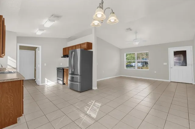 a view of a kitchen with furniture and stainless steel appliances