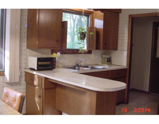 40 Winding Lane Springfield, MA 01118 - Photo 9 of 15 a kitchen with a sink cabinets and a wooden floor