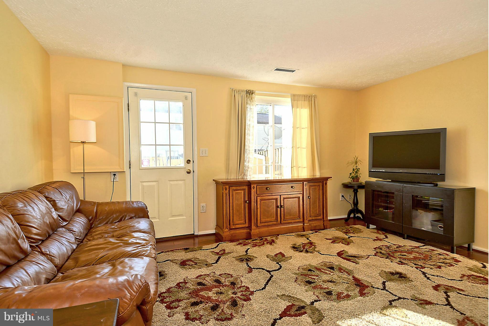 18 Cross Ridge Court Germantown, MD 20874 - Photo 2 of 30 Living Room with hardwood, backs to deck