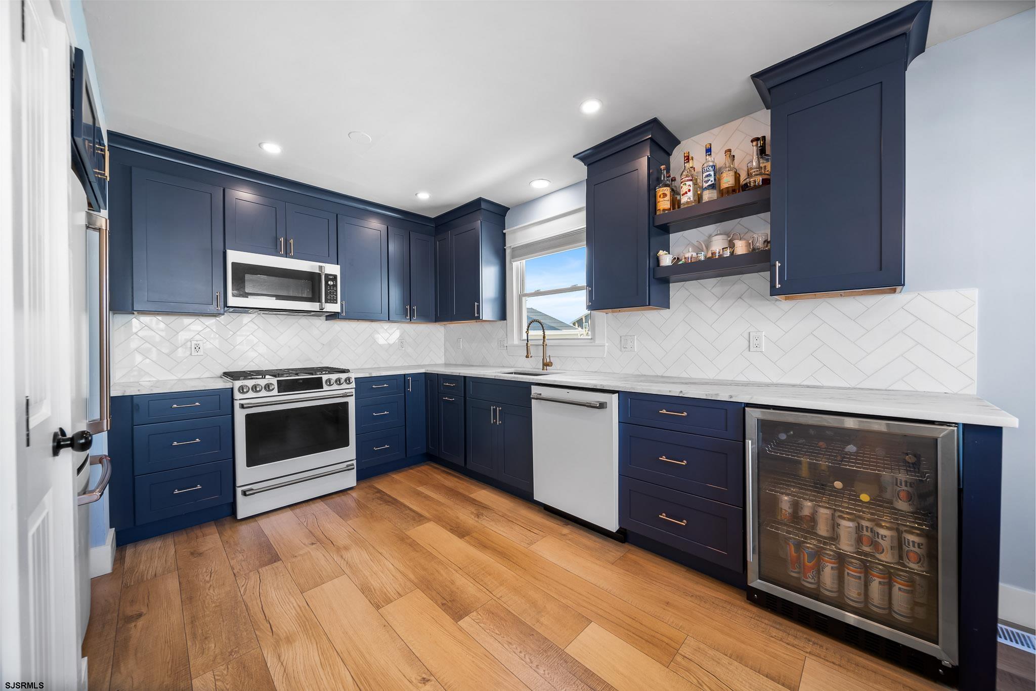7 A Lighthouse Cove, Unit A Brigantine, NJ 08203 - Photo 12 of 31 a kitchen with stainless steel appliances granite countertop a stove microwave and sink