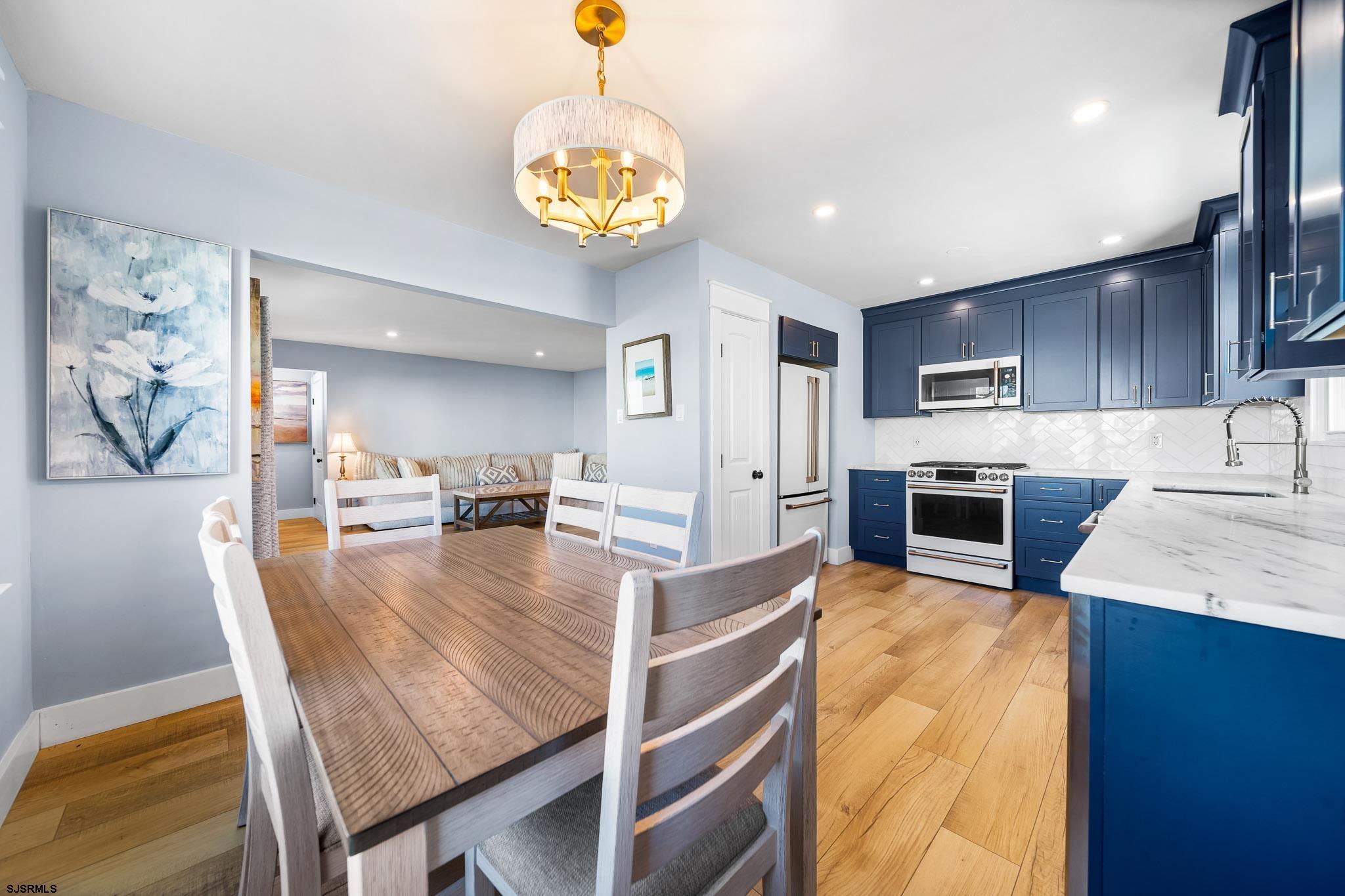 7 A Lighthouse Cove, Unit A Brigantine, NJ 08203 - Photo 15 of 31 a view of a dining room and kitchen with furniture a chandelier and wooden floor