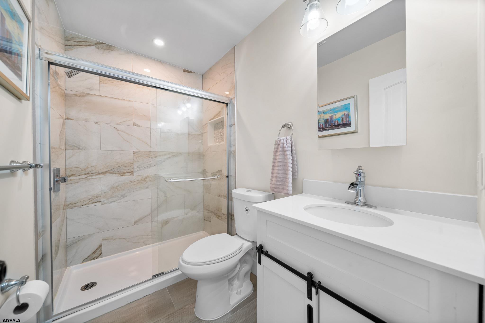 7 A Lighthouse Cove, Unit A Brigantine, NJ 08203 - Photo 16 of 31 a bathroom with a sink a toilet and shower