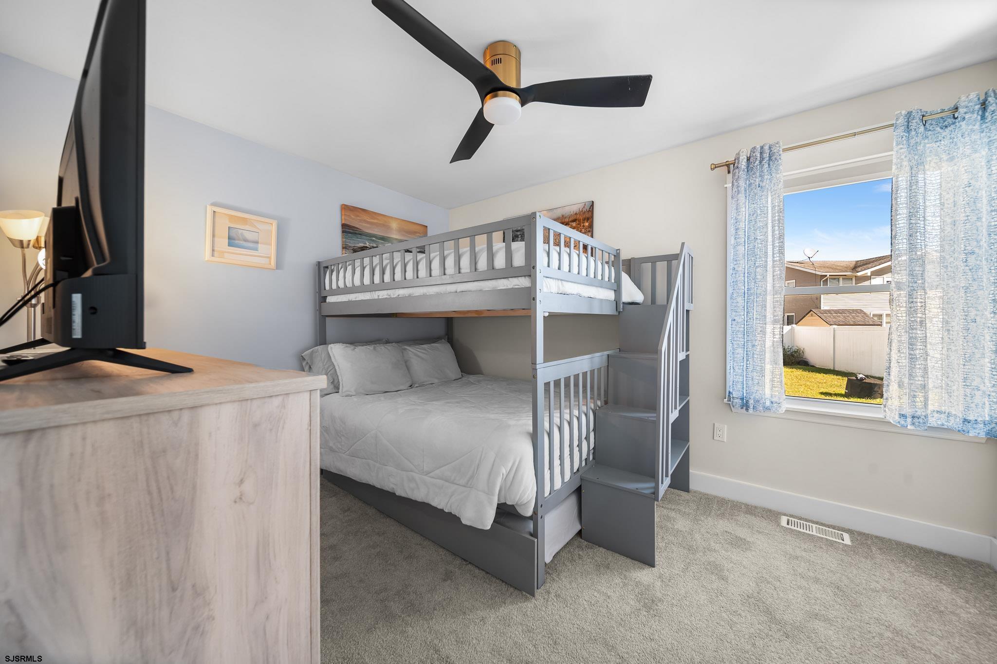 7 A Lighthouse Cove, Unit A Brigantine, NJ 08203 - Photo 17 of 31 a bedroom with a bed and a window