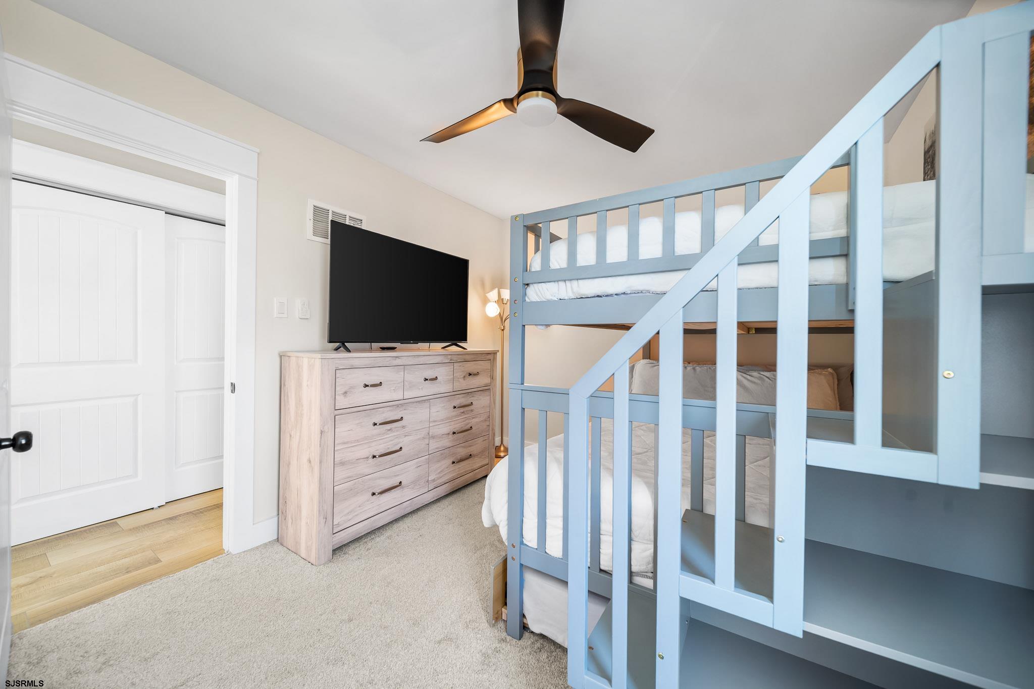 7 A Lighthouse Cove, Unit A Brigantine, NJ 08203 - Photo 18 of 31 a view of an empty room with stairs and a flat screen tv