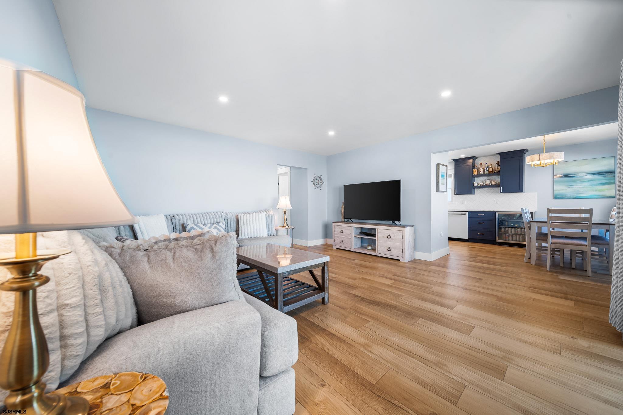 7 A Lighthouse Cove, Unit A Brigantine, NJ 08203 - Photo 7 of 31 a living room with furniture and a flat screen tv