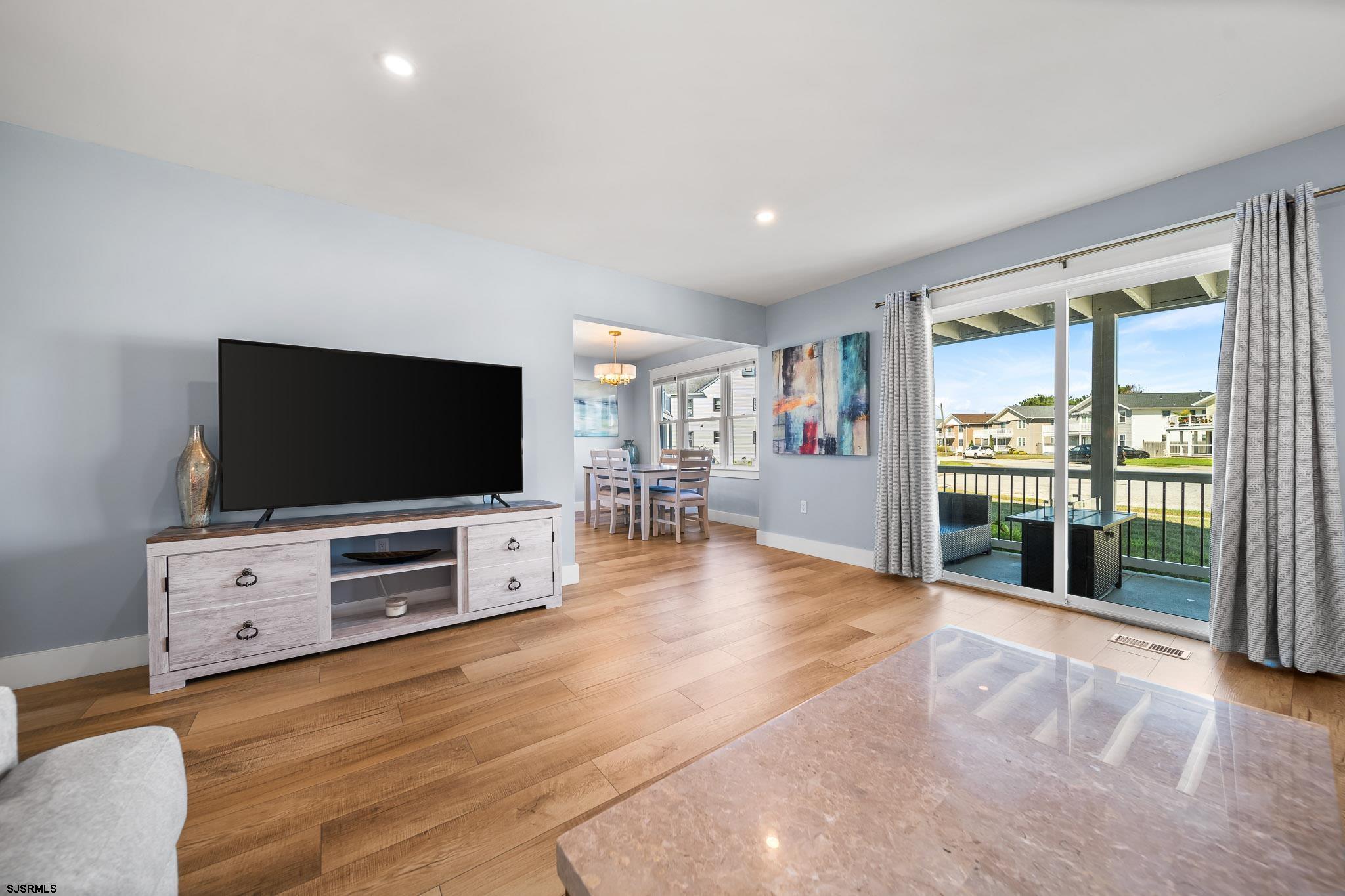 7 A Lighthouse Cove, Unit A Brigantine, NJ 08203 - Photo 10 of 31 a living room with furniture and a flat screen tv