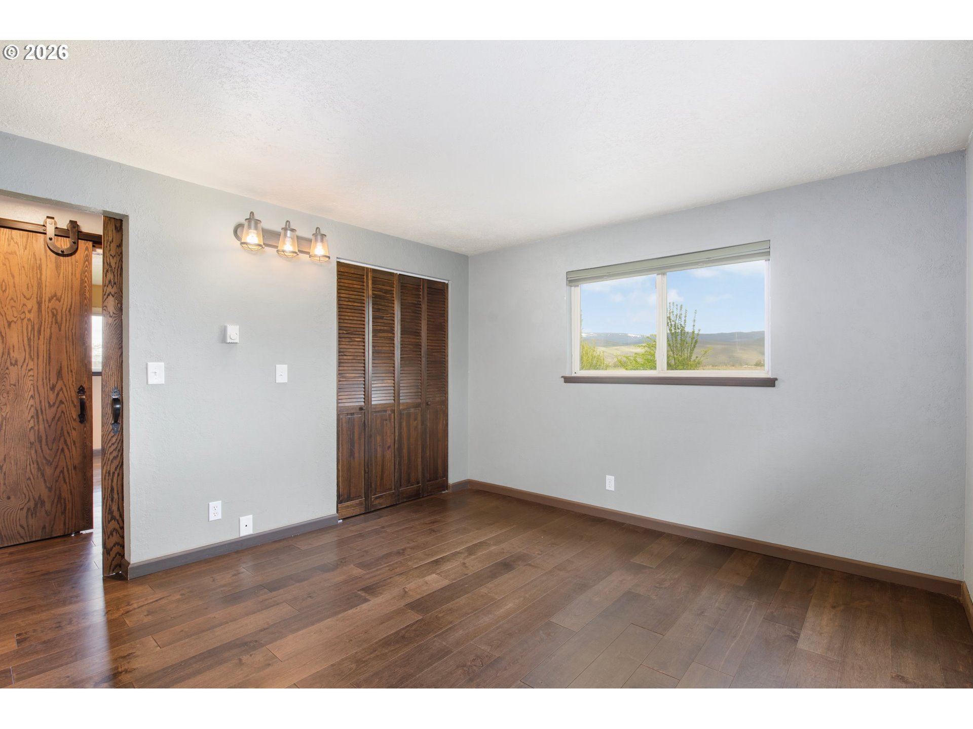 58015 Godley Road Union, OR 97883 - Photo 21 of 44 a view of an empty room with wooden floor and a window