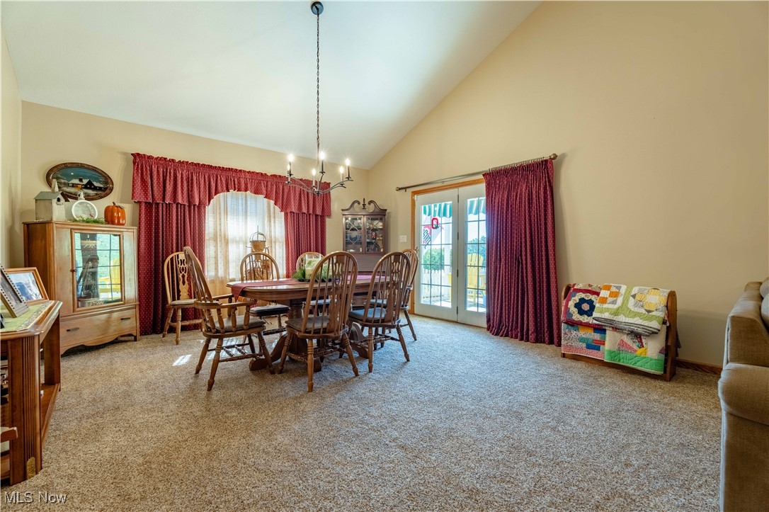 90480 Kilgore Ridge Road Scio, OH 43988 - Photo 15 of 39 Dining area with high vaulted ceiling, light carpet, french doors, and a chandelier