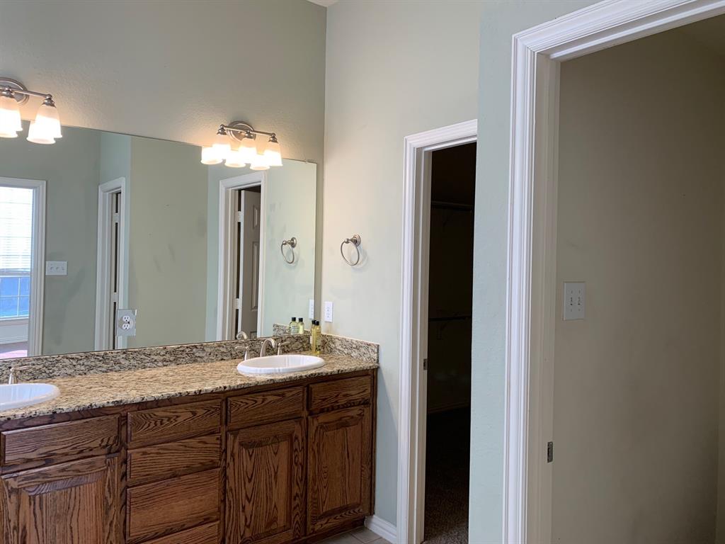 1017 Somerset Circle Forney, TX 75126 - Photo 16 of 21 a bathroom with a double vanity sink and a mirror