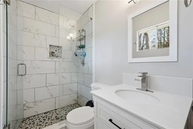 a bathroom with a sink toilet and shower