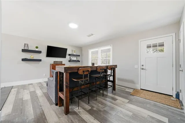 a view of a workspace with furniture and wooden floor