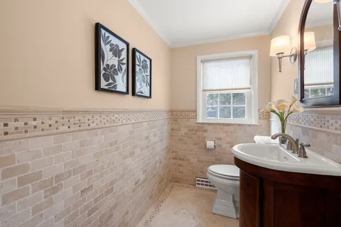a bathroom with a toilet sink and mirror