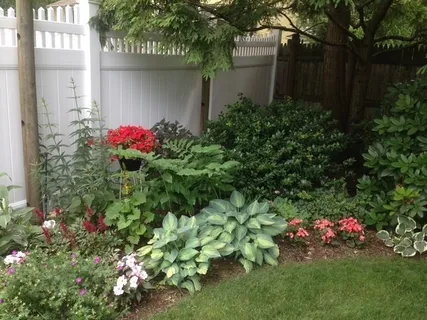 a view of a patio with couches table and chairs under an umbrella