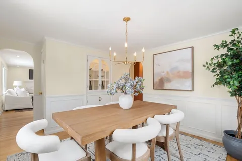 a dining room with furniture and wooden floor