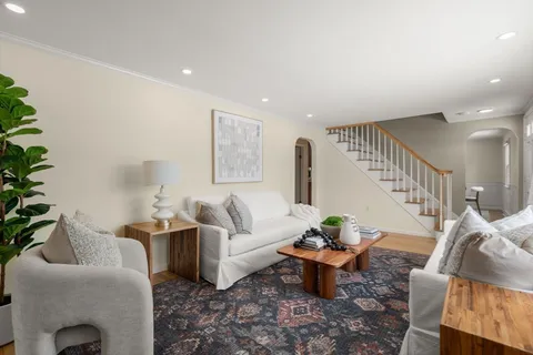 a living room with furniture and a potted plant