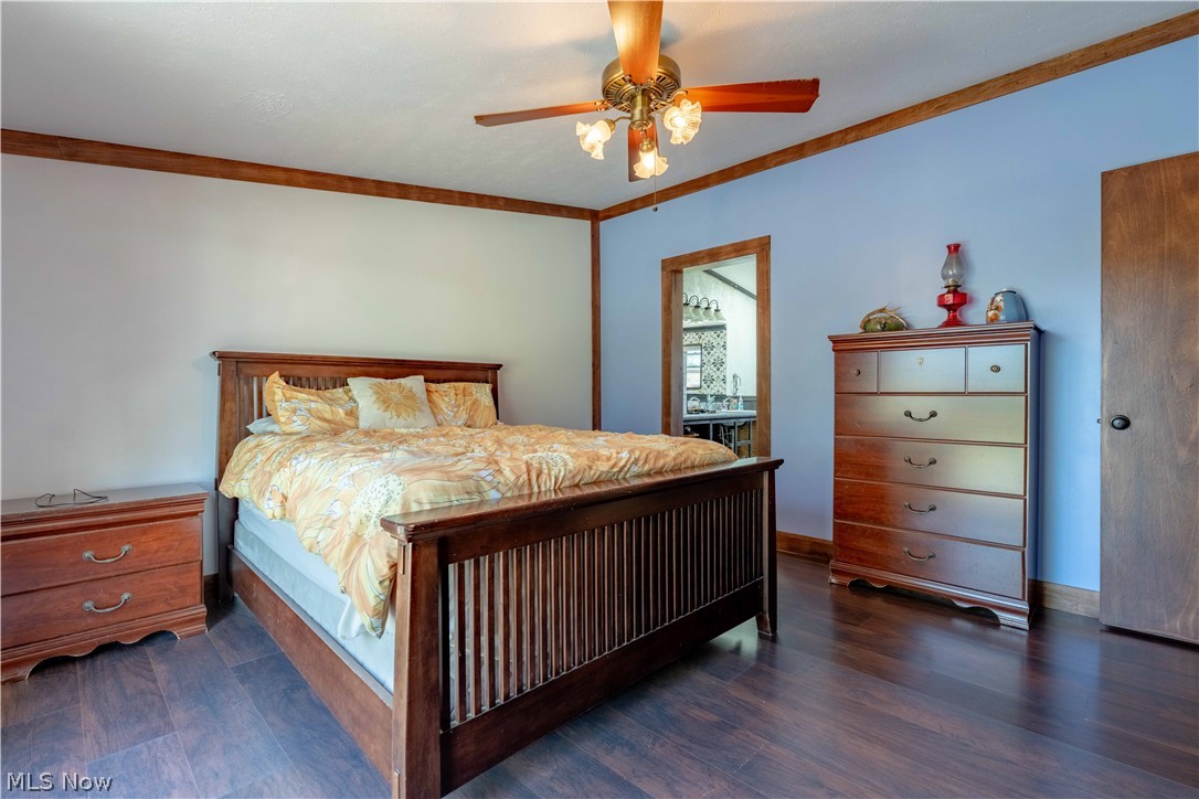 5267 Apollo Road Northeast Salineville, OH 43945 - Photo 15 of 33 Bedroom with dark wood finished floors, ceiling fan, and crown molding