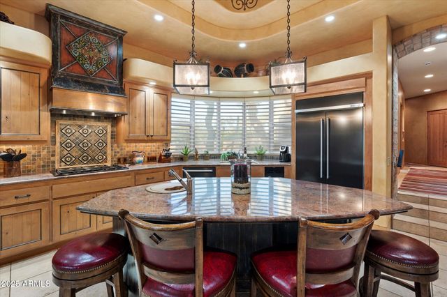 a kitchen with a dining table and chairs