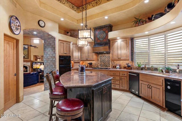 a large kitchen with a table and chairs