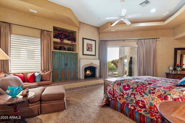 a bedroom with furniture and a fireplace