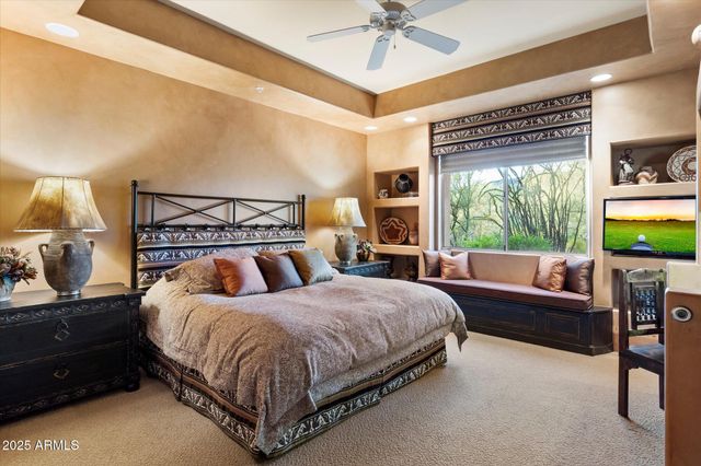 a bedroom with a large bed and a window