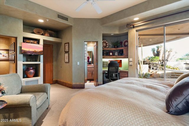 a large bedroom with a large bed and furniture