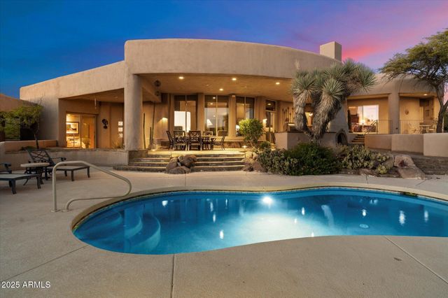 a view of a swimming pool with outdoor seating