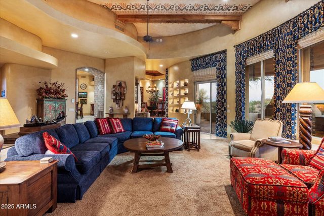 a living room with furniture a rug and a chandelier