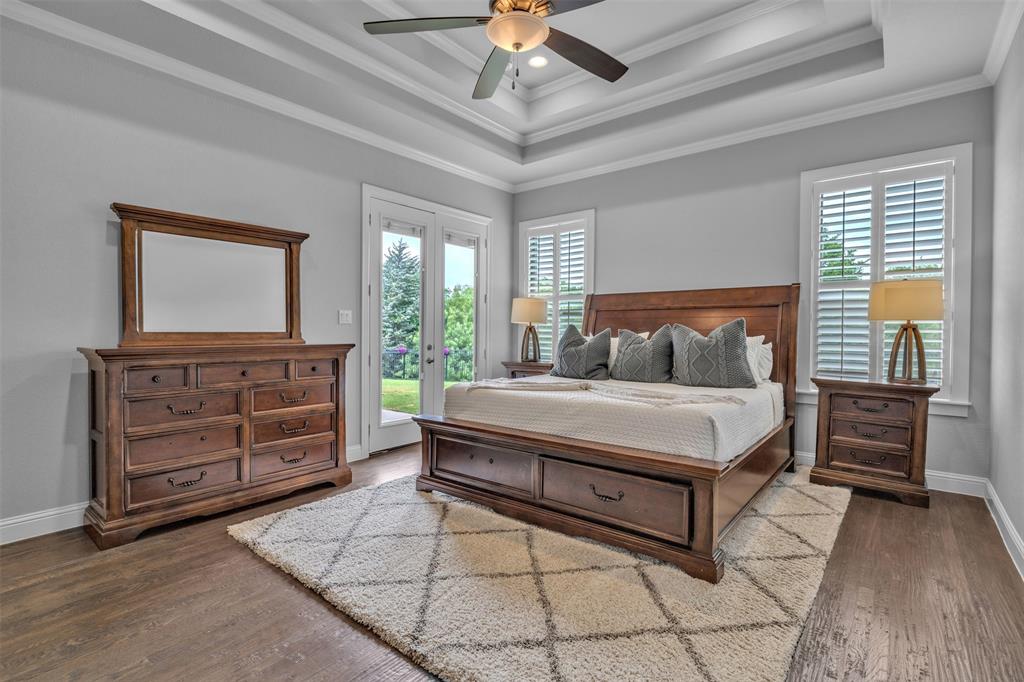 1060 Waters Edge Court Oak Point, TX 75068 - Photo 26 of 40 a bedroom with a bed and a dresser