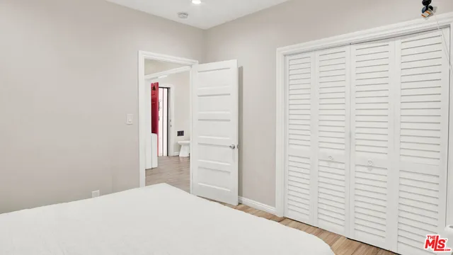 a bedroom with a bed and a bathroom