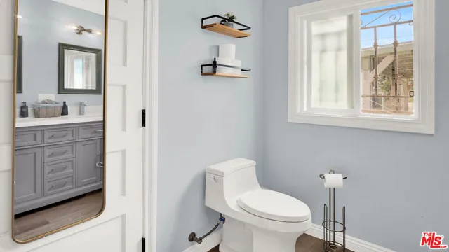 a bathroom with a toilet a sink and a window