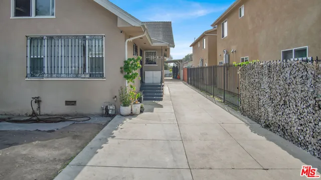 a house with potted plants in front of door