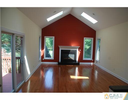16 Parker Road, Unit NONE Edison, NJ 08820 - Photo 3 of 8 a view of an empty room with wooden floor and a window