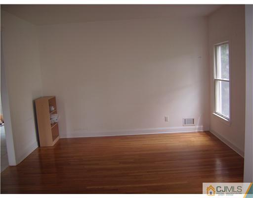 16 Parker Road, Unit NONE Edison, NJ 08820 - Photo 4 of 8 a view of an empty room and wooden floor
