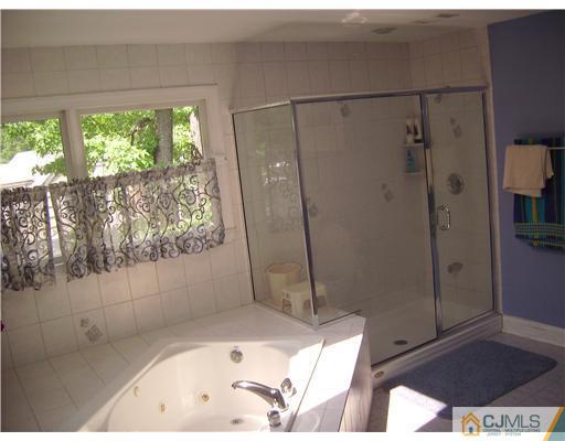 16 Parker Road, Unit NONE Edison, NJ 08820 - Photo 7 of 8 a bathroom with a bathtub and shower