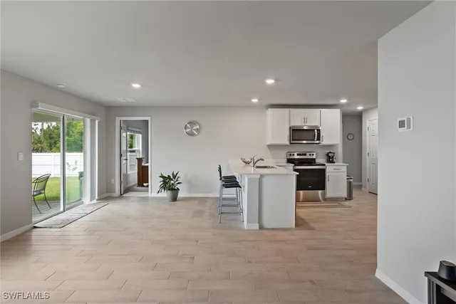 a view of a kitchen with a sink and microwave
