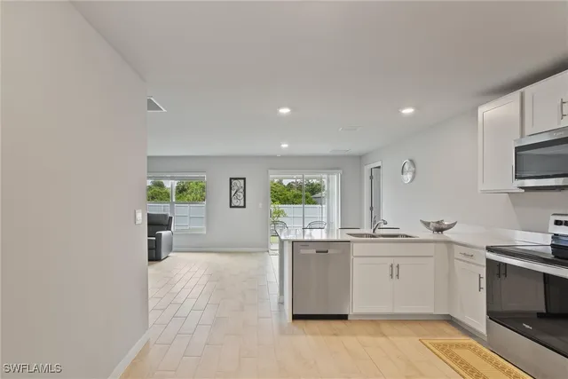 a kitchen with a sink stainless steel appliances and cabinets