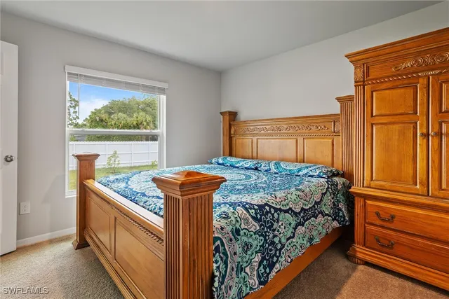 a bedroom with bed and wooden floor