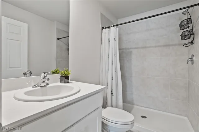 a bedroom with sink and mirror