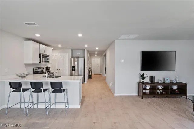 a view of a living room kitchen and a flat screen tv