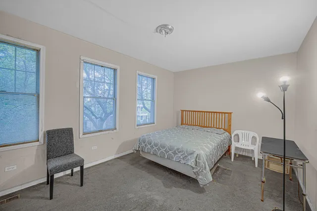 a bedroom with a bed and a chair