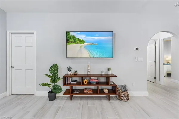 a living room with furniture and a potted plant