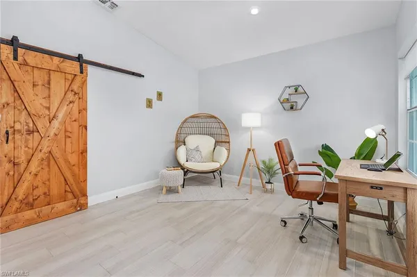 a workspace room with furniture and wooden floor