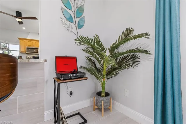 a living room with furniture and a potted plant