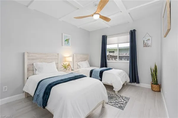 a bedroom with two beds and a window