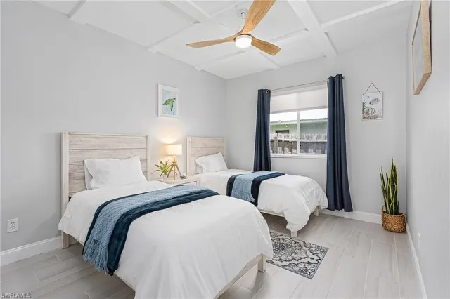 a bedroom with two beds and a window